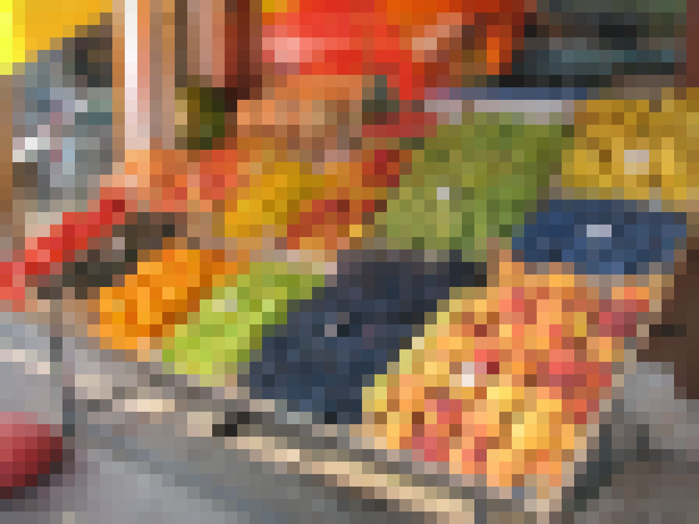 A fruit seller tends a colorful stall at the market