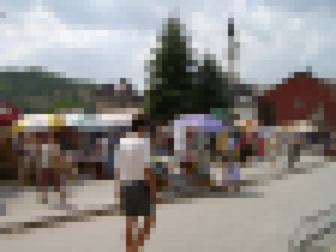People gather at an open market in Zenica